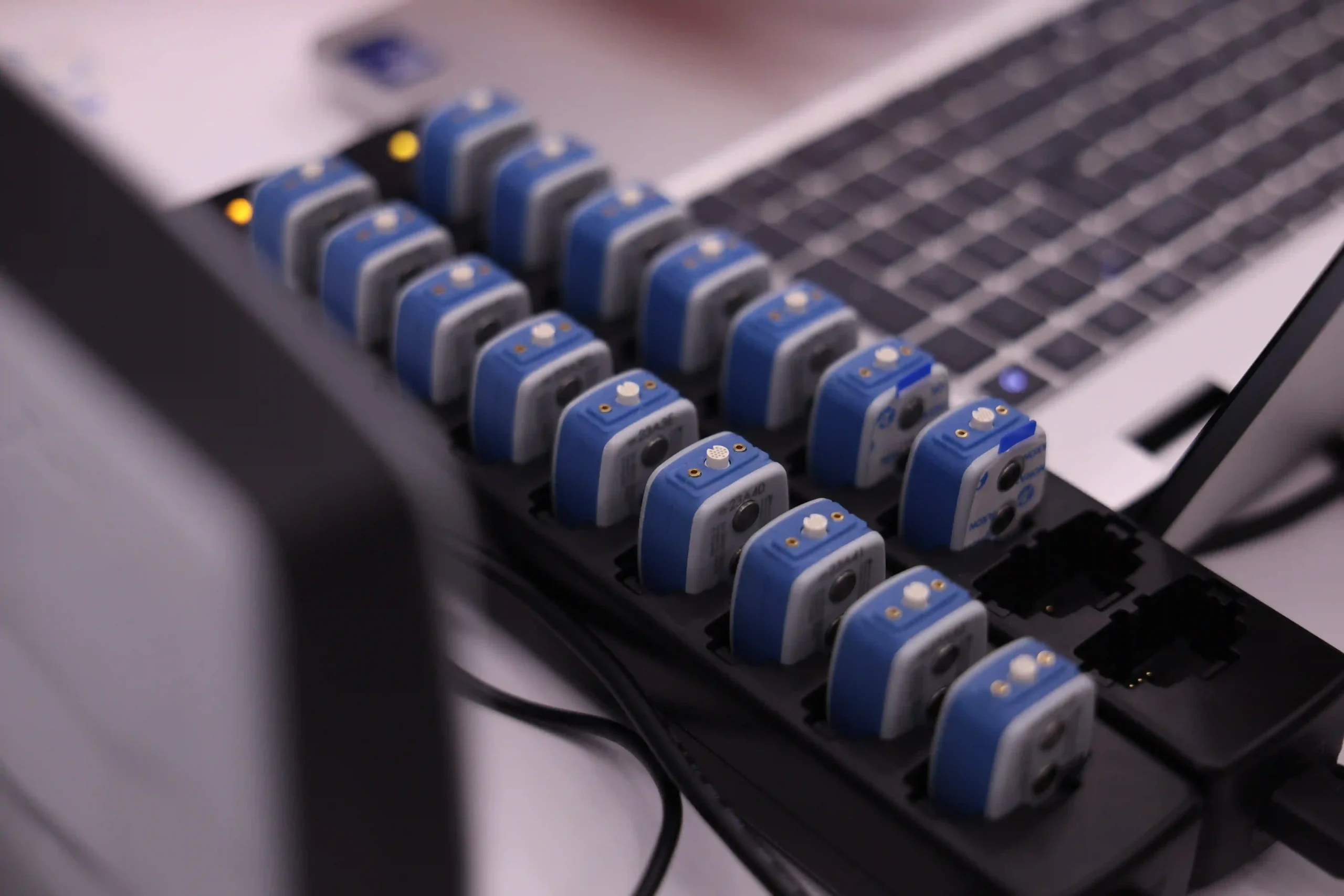Wireless surface EMG sensors in their charging cradle